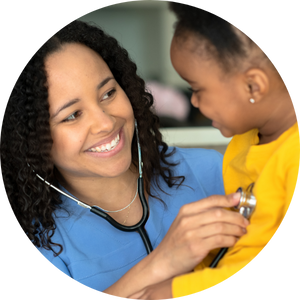 school nurse holding stethoscope to the chest of a young girl